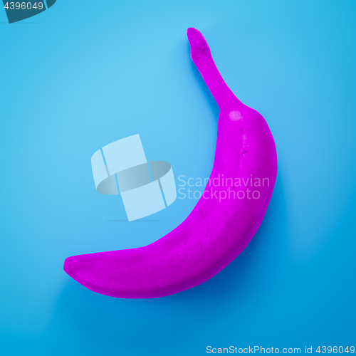 Image of a pink banana on turquoise background
