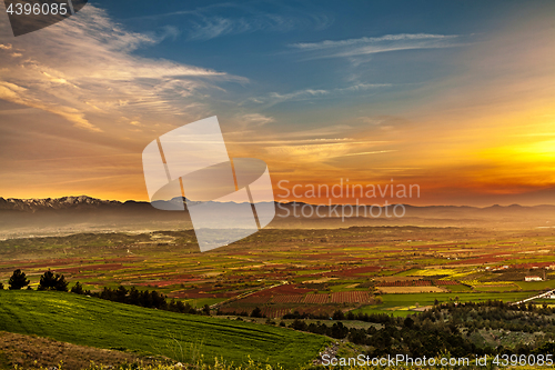 Image of Beutiful sunset over colored agricultiral fields