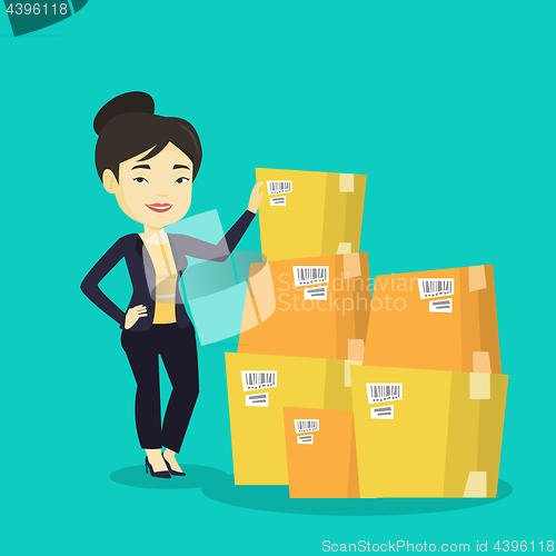 Image of Business woman checking boxes in warehouse.