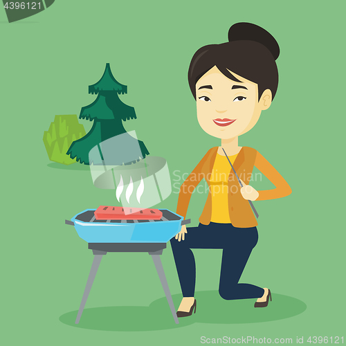 Image of Woman cooking steak on barbecue grill.