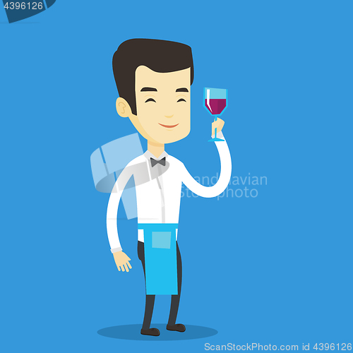 Image of Bartender holding a glass of wine in hand.