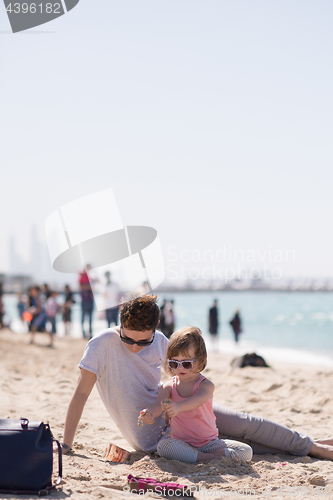 Image of Mom and daughter on the beach