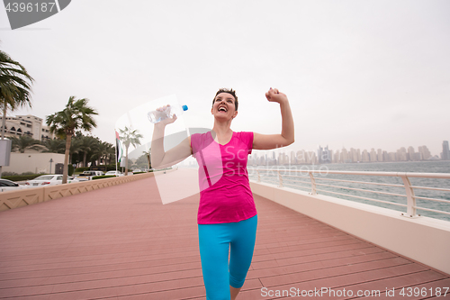 Image of young woman celebrating a successful training run