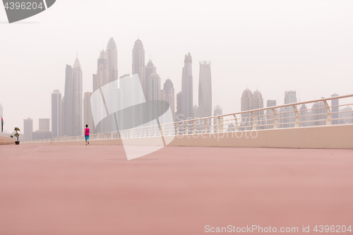 Image of woman running on the promenade