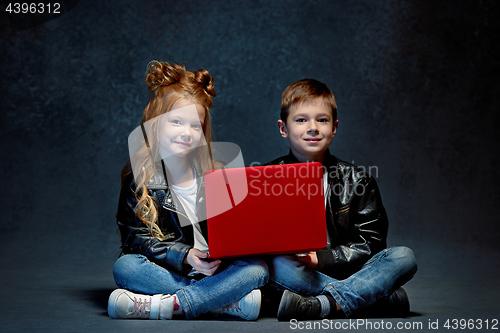 Image of Studio shot of two children with laptop