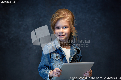 Image of Little girl sitting with tablet