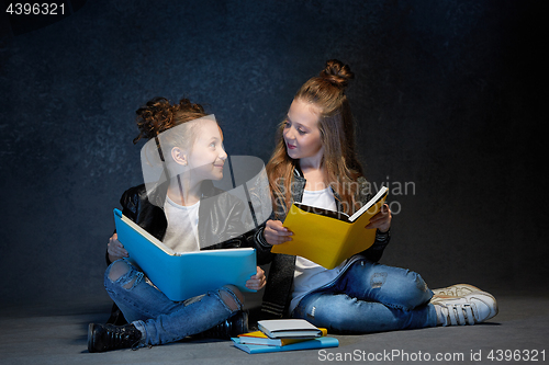 Image of Two kids reading the books at studio