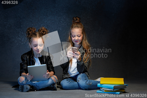 Image of Two kids reading the books at studio