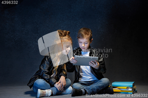 Image of Studio shot of two children with laptop