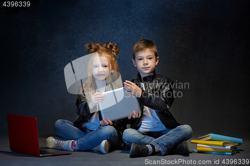 Image of Studio shot of two children with laptop