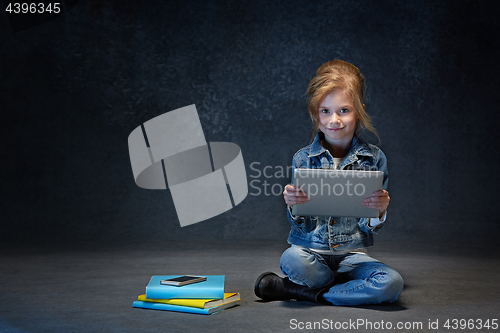 Image of Little girl sitting with tablet