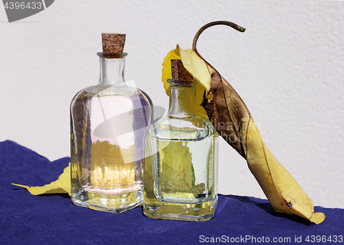 Image of Small Bottles and Yellow Leaves