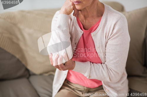 Image of close up of senior woman having hand ache at home