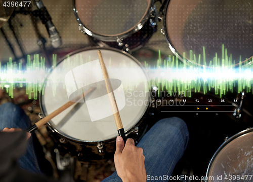 Image of male musician playing drum kit at concert