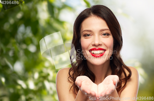 Image of beautiful smiling young woman with red lipstick