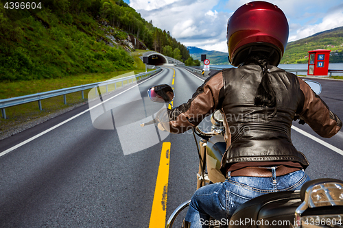 Image of Biker girl First-person view, mountain serpentine.