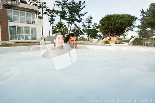 Image of Young couple in a jacuzzi