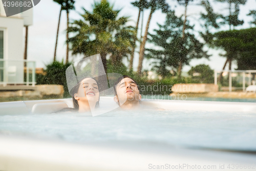 Image of Young couple in a jacuzzi