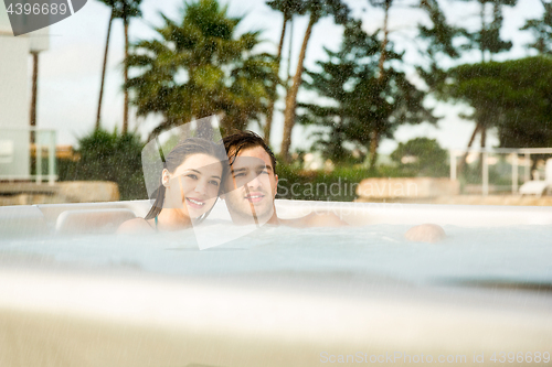 Image of Young couple in a jacuzzi