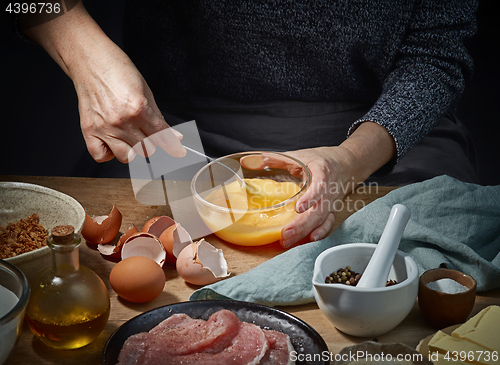 Image of female hands is bitten eggs 