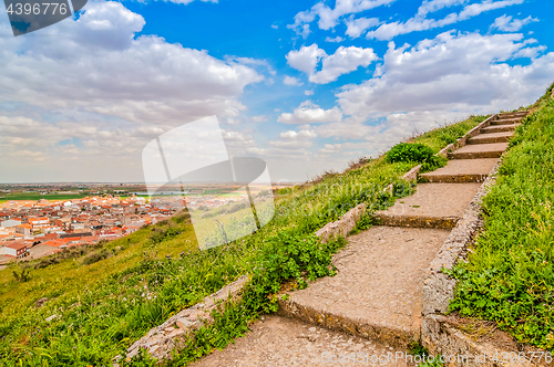 Image of Staircase to the sky. Huge stairway leading up a green hill