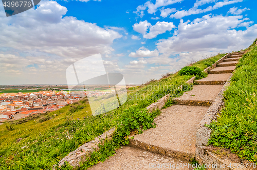 Image of Staircase to the sky. Huge stairway leading up a green hill