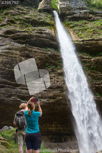 Image of Active tourists looking at Pericnik waterfall in Vrata Valley in Triglav National Park in Julian Alps, Slovenia.