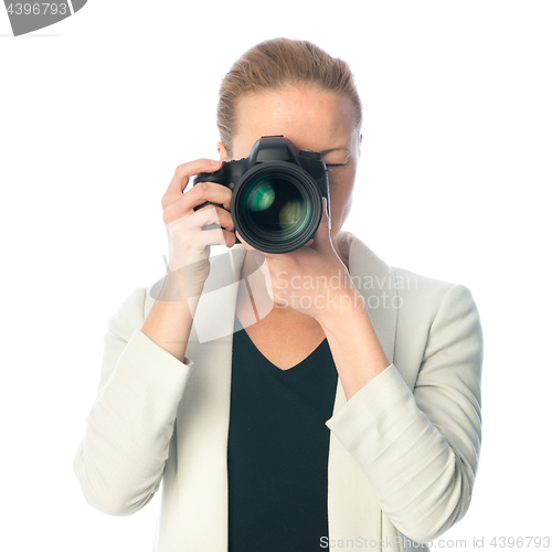 Image of Beautiful young photographer with camera in professional studio