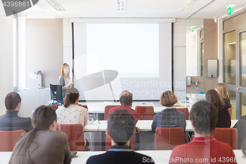 Image of Woman giving presentation in lecture hall at university.