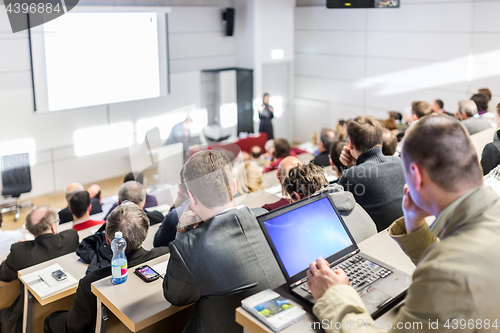 Image of Business speaker giving a talk at business conference event.