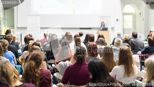 Image of Woman giving presentation in lecture hall at university.