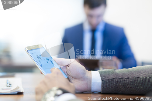 Image of Close up of businessman using mobile smart phone.