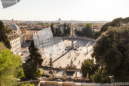 Image of Aerial view of people, sculptures, fountain and churches on Piazza del Popolo in Rome, Italy.