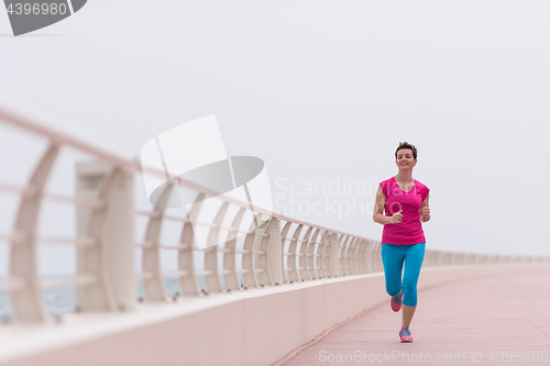 Image of woman busy running on the promenade