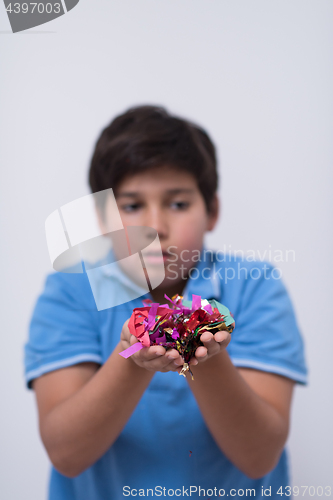 Image of kid blowing confetti