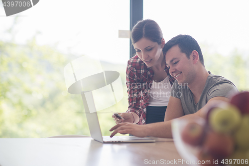 Image of happy young couple buying online