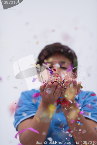 Image of kid blowing confetti