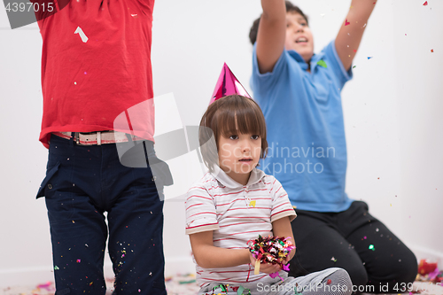 Image of kids  blowing confetti