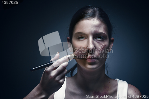 Image of Close up portrait of a crying woman with bruised skin and black eyes