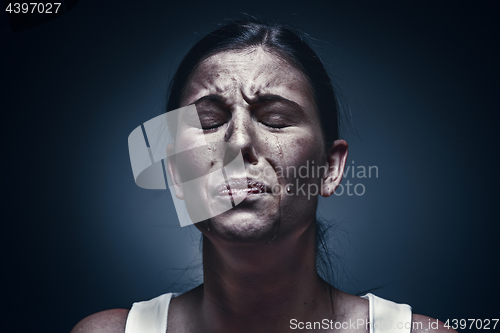 Image of Close up portrait of a crying woman with bruised skin and black eyes