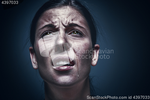 Image of Close up portrait of a crying woman with bruised skin and black eyes