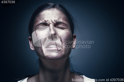 Image of Close up portrait of a crying woman with bruised skin and black eyes