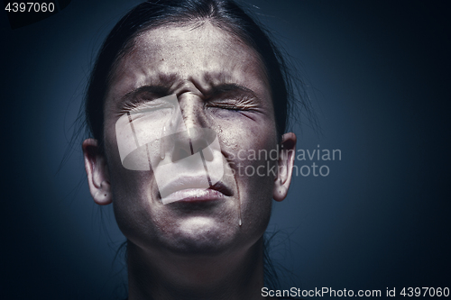 Image of Close up portrait of a crying woman with bruised skin and black eyes