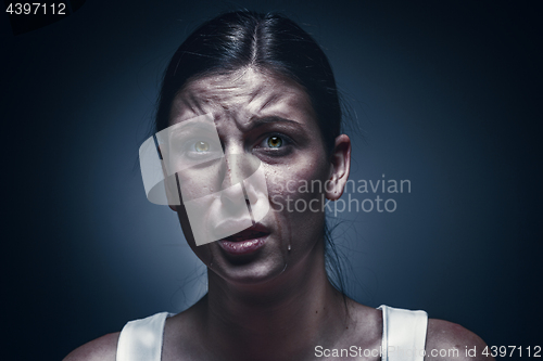 Image of Close up portrait of a crying woman with bruised skin and black eyes