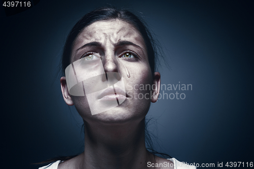 Image of Close up portrait of a crying woman with bruised skin and black eyes