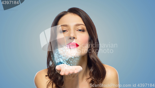 Image of beautiful woman blowing to low poly projection