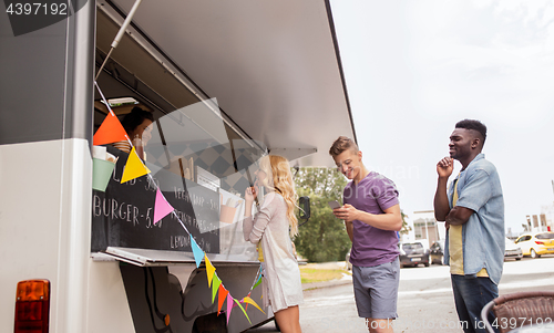 Image of happy customers queue at food truck