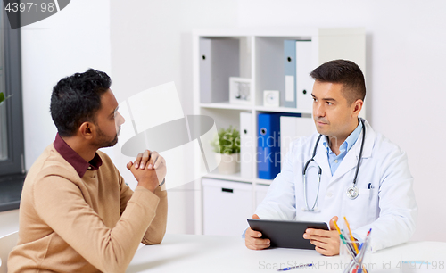 Image of doctor with tablet pc and male patient at hospital