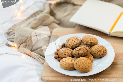 Image of oatmeal cookies with almonds on plate at home