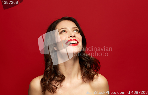 Image of beautiful smiling young woman with red lipstick